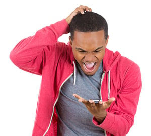 Closeup portrait of handsome young man shocked surprised, open mouth and eyes, mad by what he sees on his cell phone, isolated on white background. Negative human emotion facial expression feeling