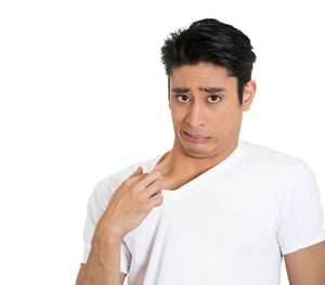Closeup portrait of young business man opening shirt to vent, it's hot, unpleasant, awkward situation, embarrassment. Isolated white background. Negative human emotions, facial expression, feelings